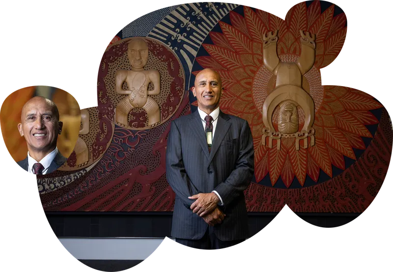 RealMe photo of Maori man in business suit in front of decorative Maori panels